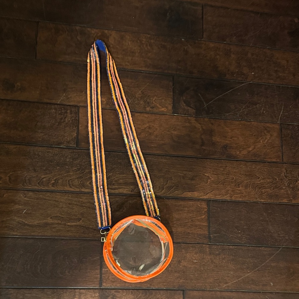 Clear Round Crossbody Bag with Orange Trim and Striped Strap